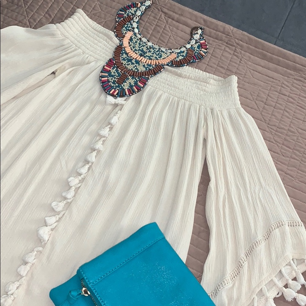 Off the shoulder top with decorative tassels